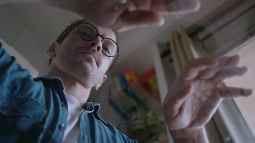 Man with glasses with hands on a transparent table