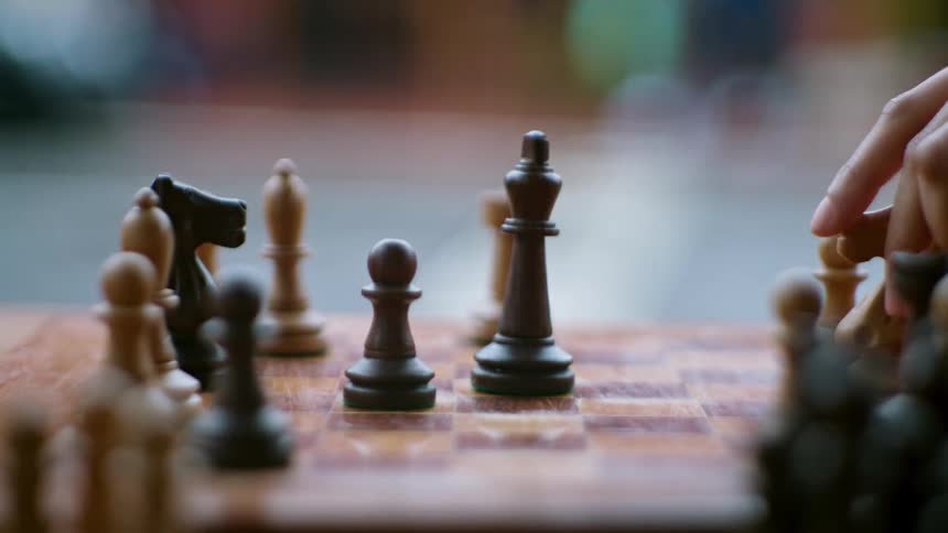 Hands of two people playing chess