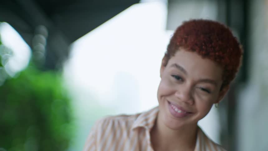 A woman smiles after winning a chess game