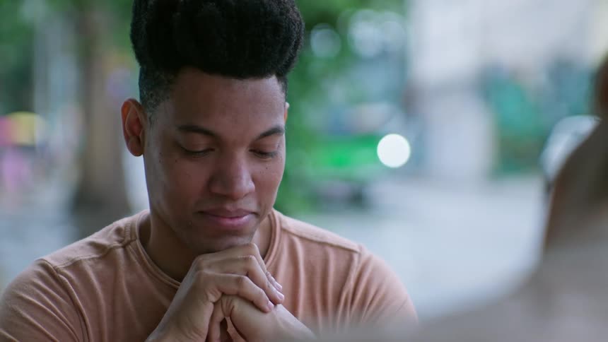Two friends are having a conversation together outdoors in a city