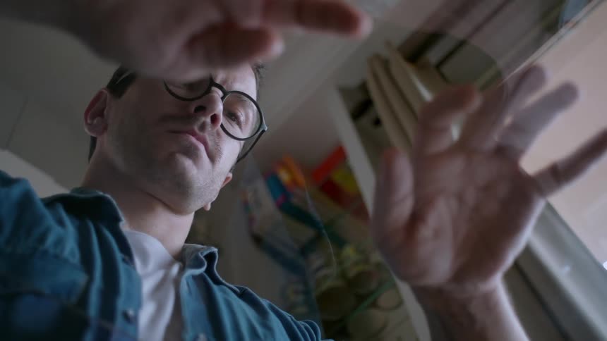 Man with glasses with his hands on a table