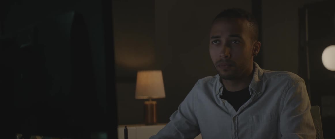 A man sits in front of a computer