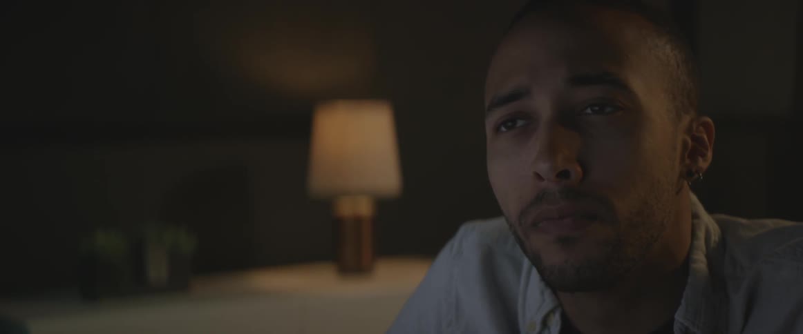 A man blinks and leans forward