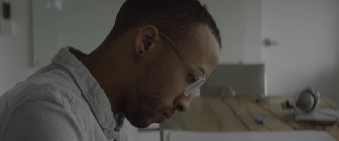 A man draws on some plans