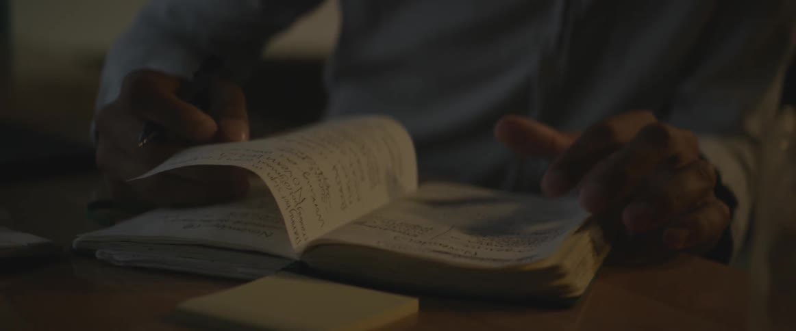 A person is reading a book on the table