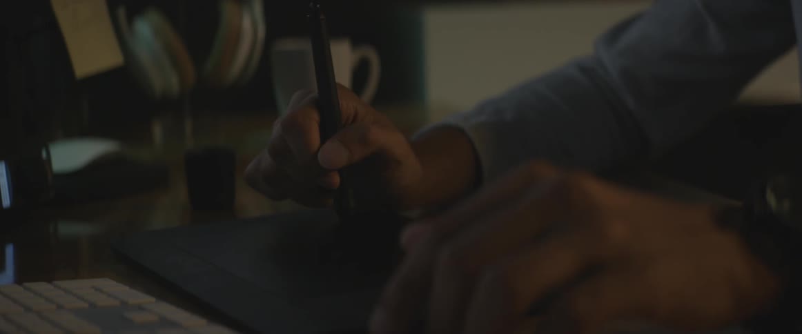 A person is writing on a device