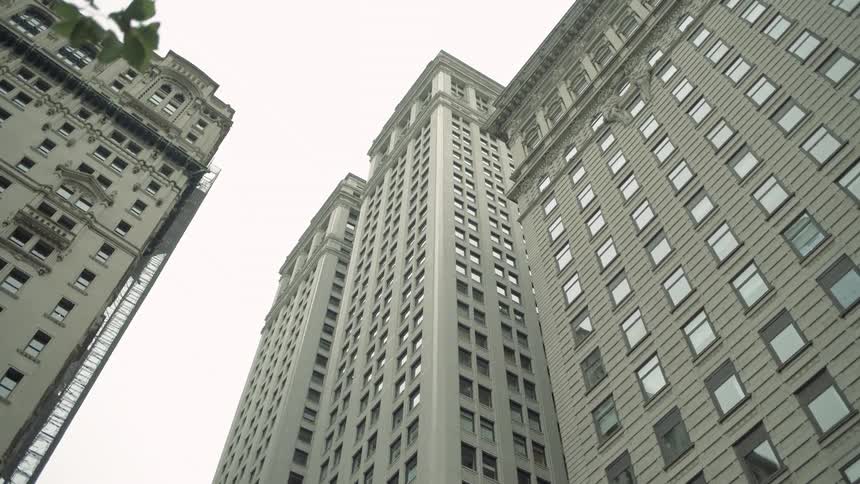 Upward view of huge buildings against a cloudy sky
