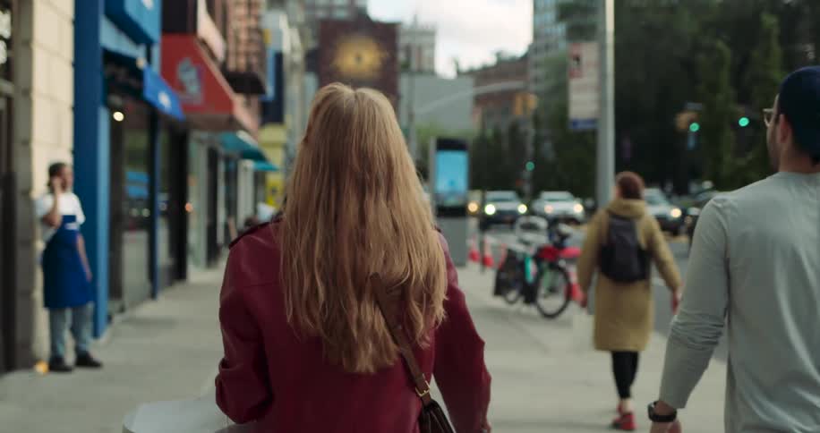 Pedestrians walking through a downtown city in the spring