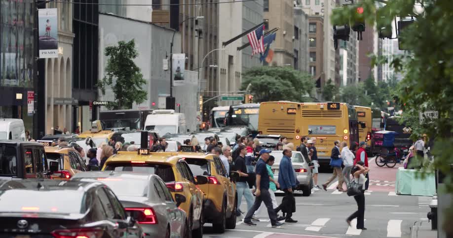 A busy street intersection in a metropolitan city during daytime