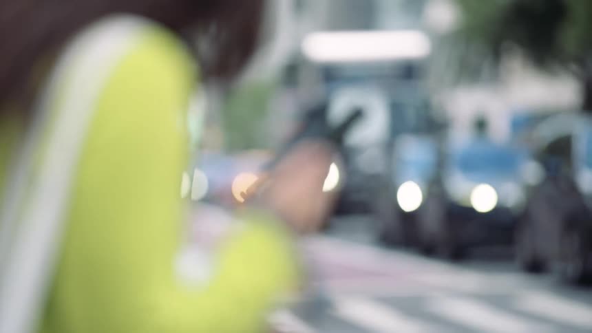 Pedestrians on an urban road in a metropolis with vehicle traffic
