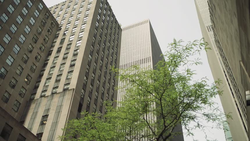 Looking up on a cloudy day with skyscrapers