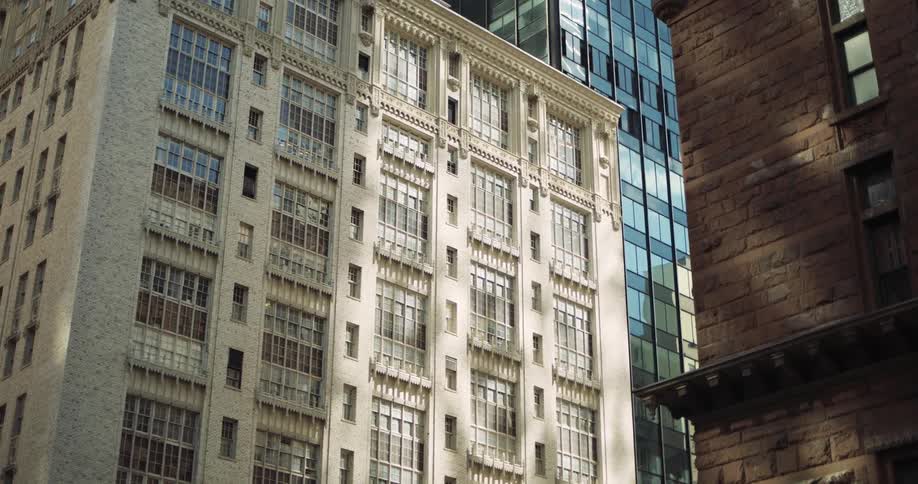 Ornate historic buildings stand side by side in an urban setting