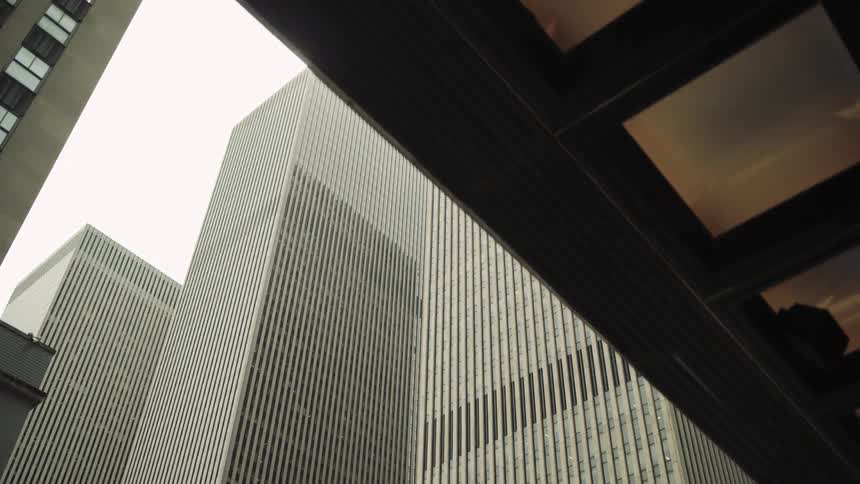 Upward view of skyscrapers against a cloudy sky