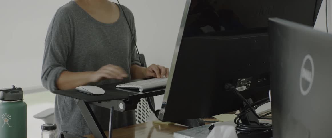 A girl is typing on a keyboard