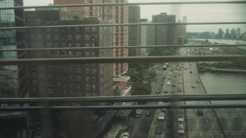Buildings in a metropolis on the edge of a highway with a sea canal