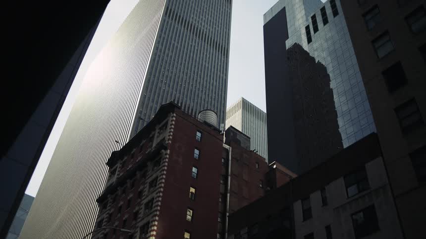 Upward view of modern skyscrapers against a cloudy sky