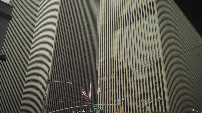 Pedestrians and vehicle traffic on a street in a metropolis with skyscrapers