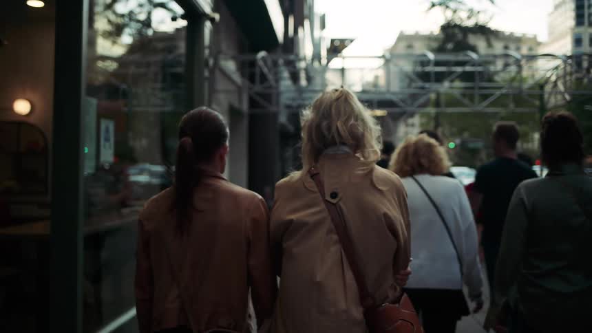 People walking on the sidewalk through urban city