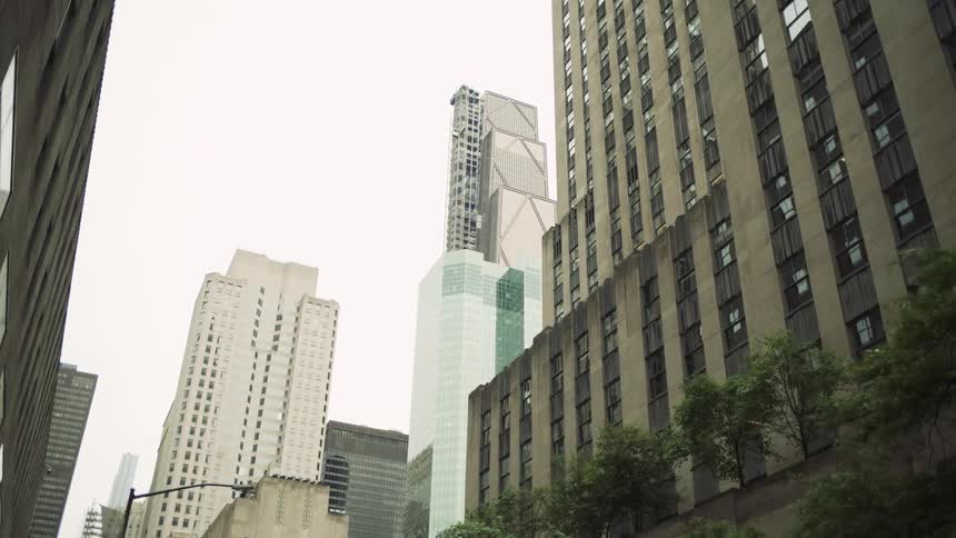 Upward view of a city with buildings on a cloudy day