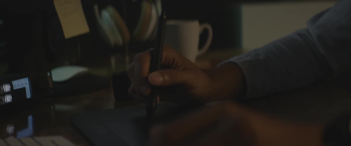 A man uses a stylus pen at a workstation
