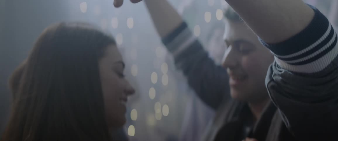 Young people dance and mingle at a party