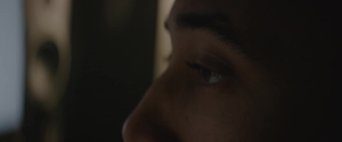 A person is looking around in a dark room