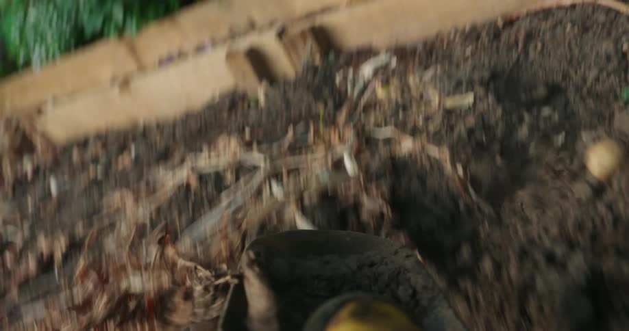 Father taking soil and throwing it to another sector