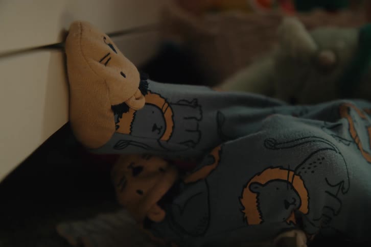 Legs of a baby lying down wearing pajamas