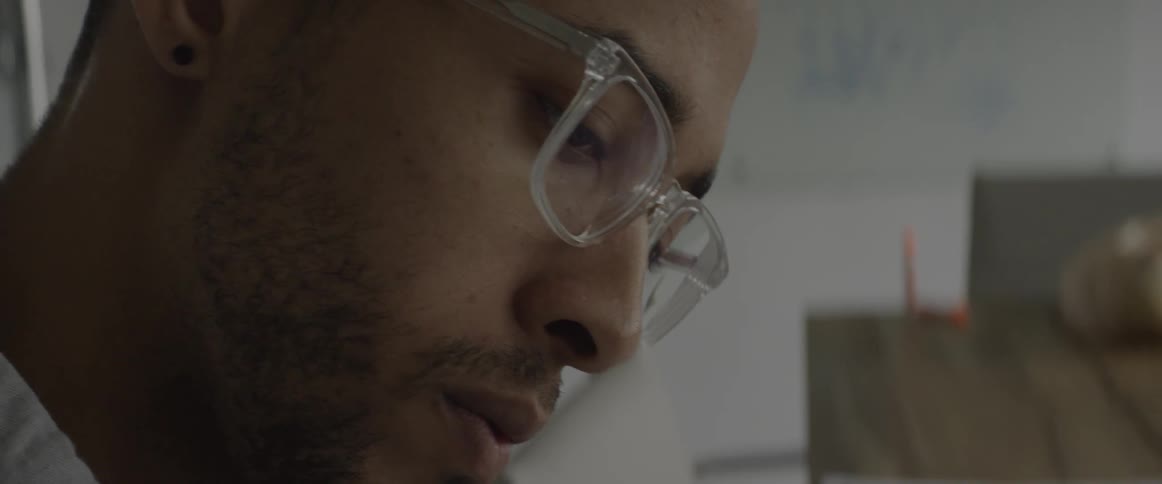 A man sits at a table and works