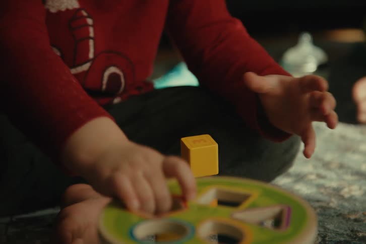 Pair of hands of a child playing with toys