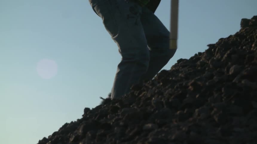 A person climbing up a rocky hill