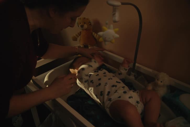 Mother playing with her baby lying down