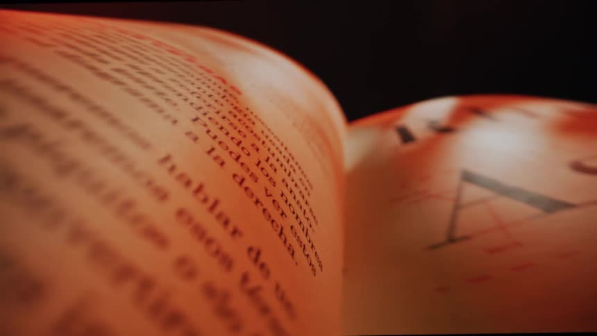 Close up of pages of a book flipped in a dark room