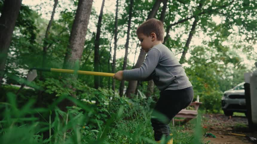 Boy playing weeding in a natural area