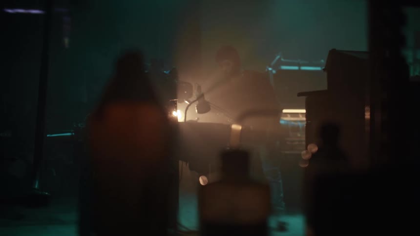 A man is working in the dark warehouse