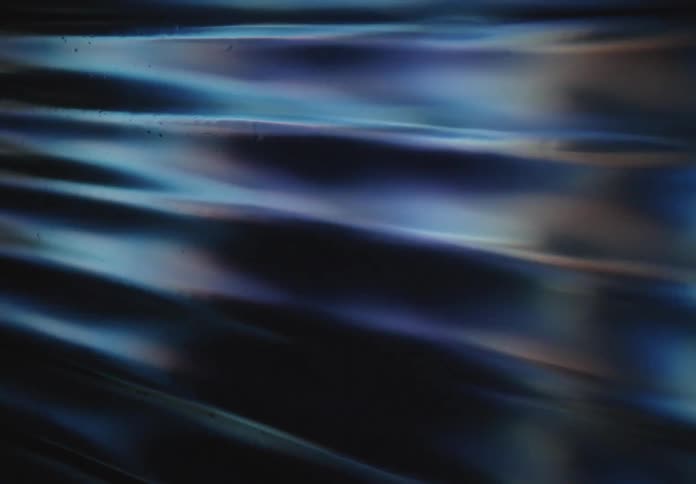 A closeup view reveals a pixelated screen displaying large yellow starlike shapes the camera pans across the textured digital surface highlighting the individual pixels that form the vibrant imagery