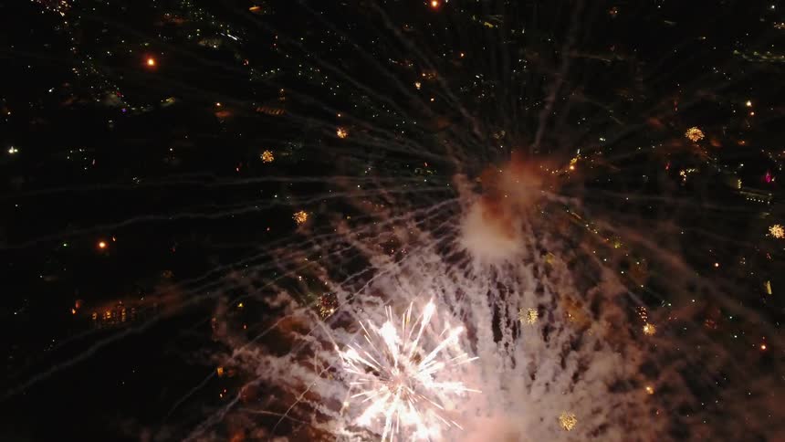 Fireworks are going off in a night sky