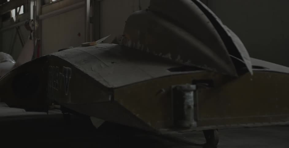 A wooden boat in a dim room