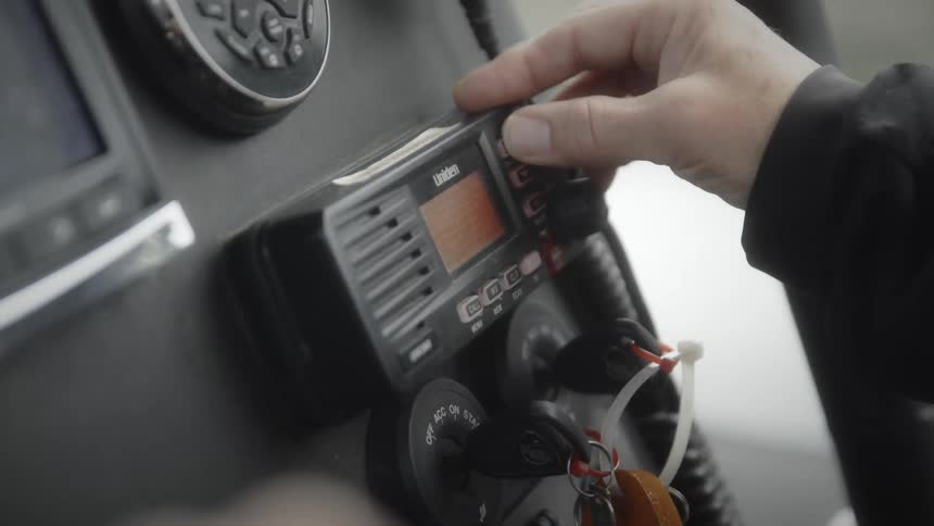 Man presses button on radio in the vehicle