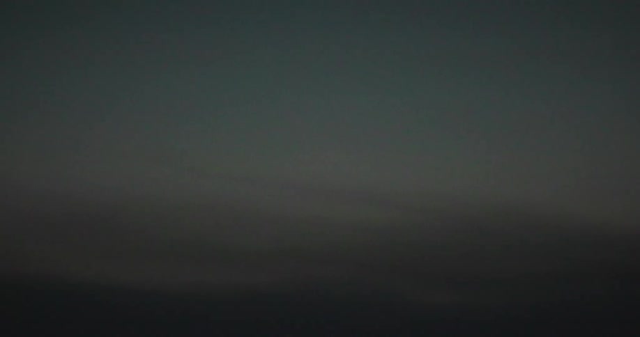 Blurred view of a dark maritime sky moving by