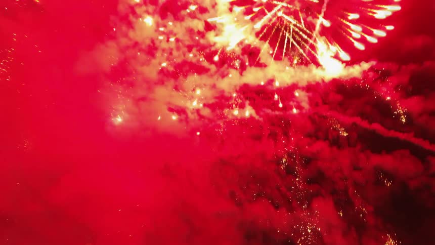 Large fireworks fill the night sky