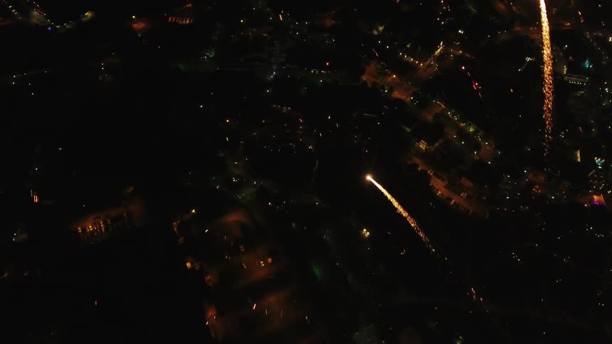 Fireworks going off in the night sky over a city