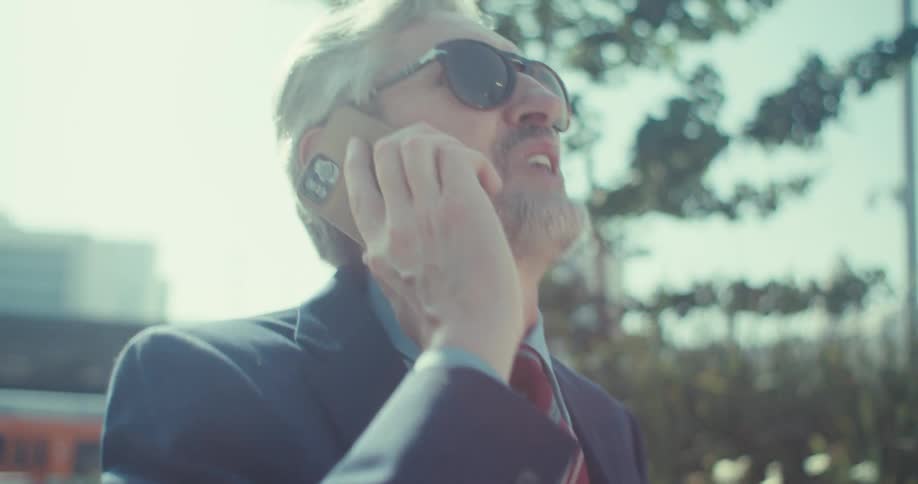 Man on a phone call laughing and enjoying a happy conversation