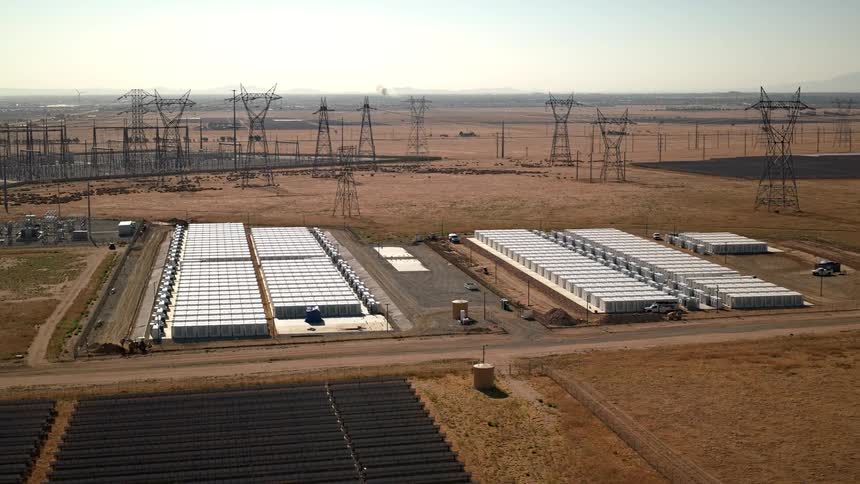 Aerial view of an area with solar panels and transmission antennas