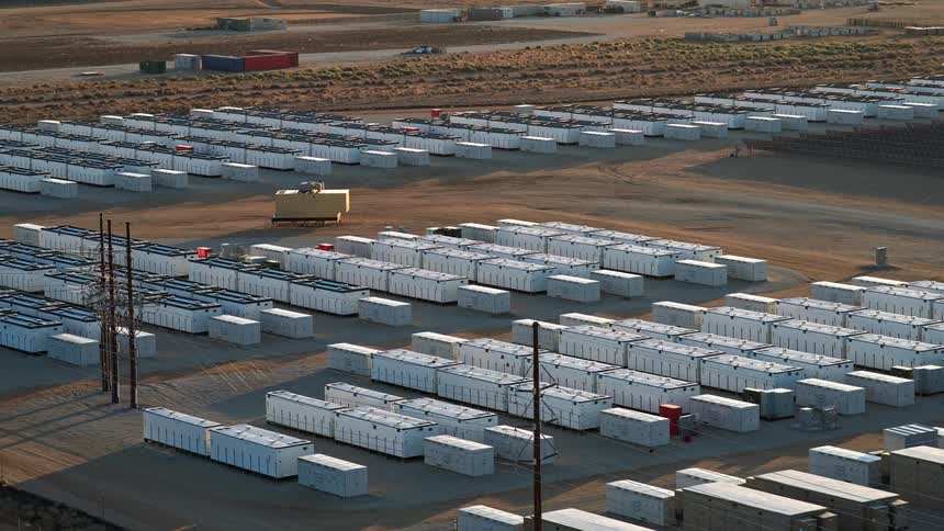 Numerous battery energy storage systems sitting idle at dawn aerial view