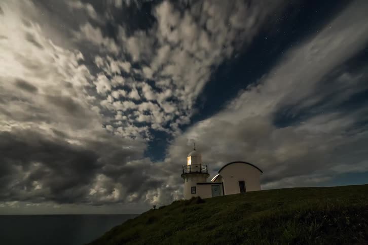 Clouds float over a lighthouse