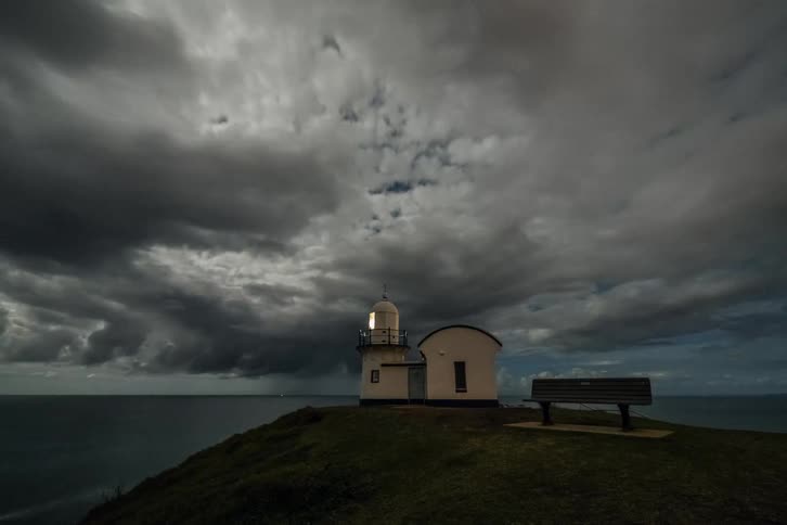 A time lapse of a lighthouse with dark clouds