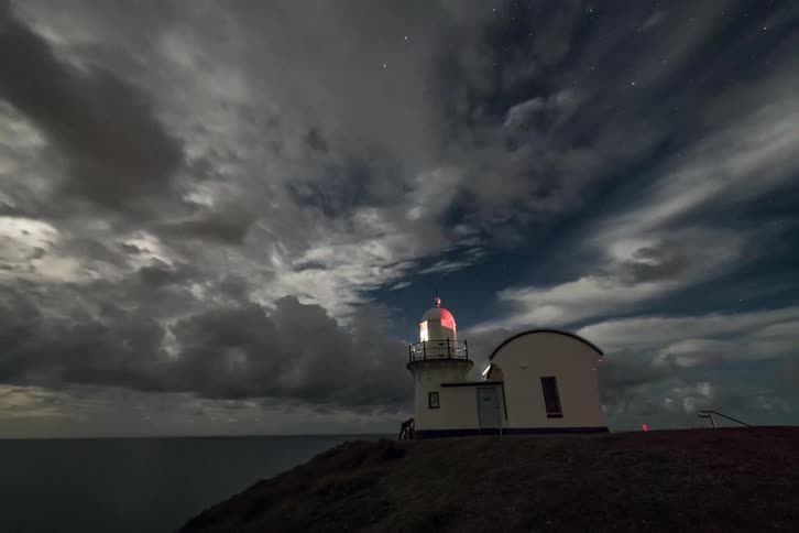 Clouds float over a lighthouse