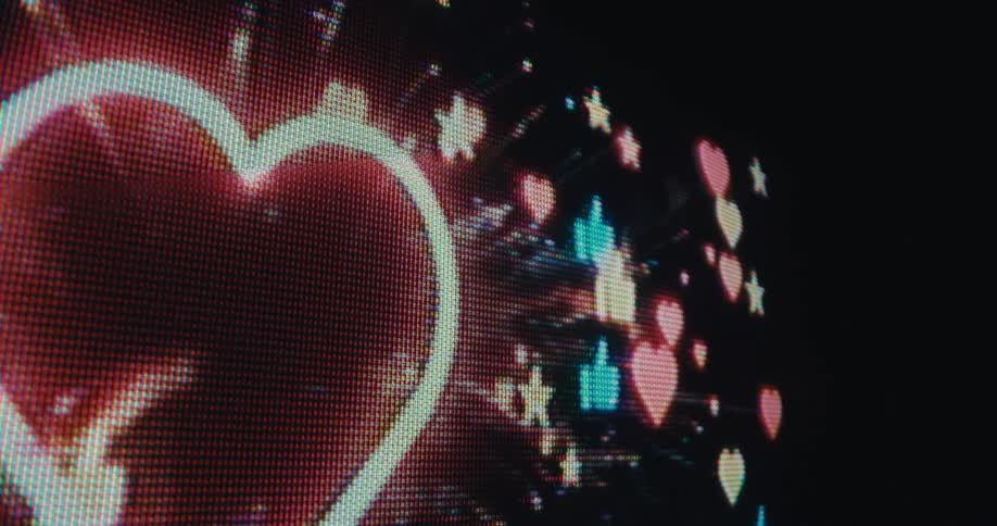Bright pixelated hearts and flames glow on a dark screen
