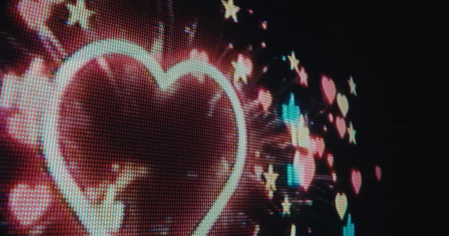 Screen displaying explosion of colorful hearts